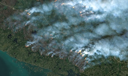 This handout satellite image from 16 August shows fires burning in Yellowknife, Northwest Territories, Canada.