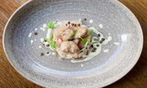 Sweetbreads on sauerkraut on a round bowled blue plate