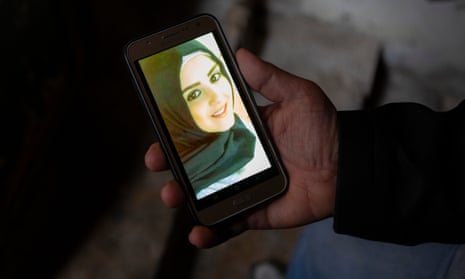 Mohamed Khodor with a photograph of his daughter Hanaa on his phone