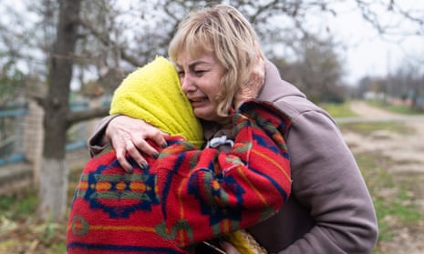Svitlana Striletska, right, cries as she hugs 84-year Galina Timofievna, left, in the liberated village of Pravdyne, Kherson region, on 12 November 2022.
