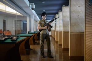 Instructor Kim Ju Yang holds a North Korean-made assault rifle as she poses for a portrait at the Meari shooting range.