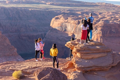 Tourist at the Horseshoe Bend overlook during sunset.
