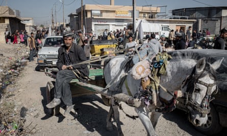 People shopping at a street market in the Gogali neighbourhood of eastern Mosul.