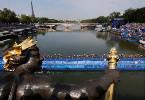 The competitors dive into the Seine during the men’s triathlon at Pont Alexandre III.