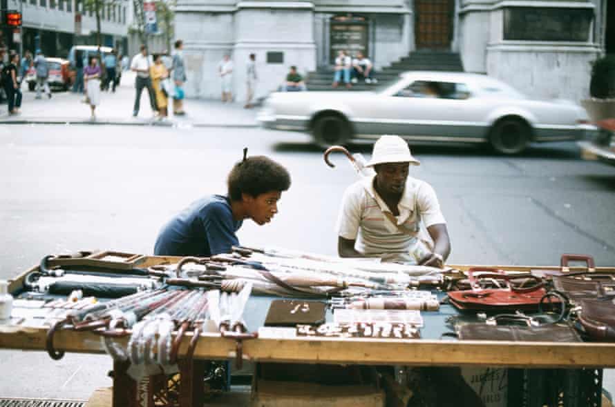 Street vendors selling an array of umbrellas, leather bags, watches and sunglasses on a New York street in 1979.