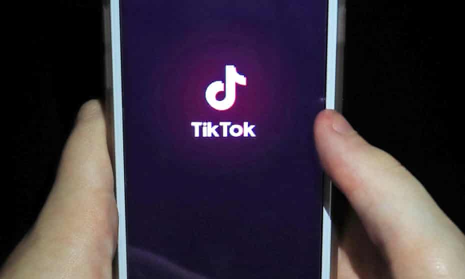 The TikTok app on a smartphone. The video-sharing app says it is working to remove the graphic footage.