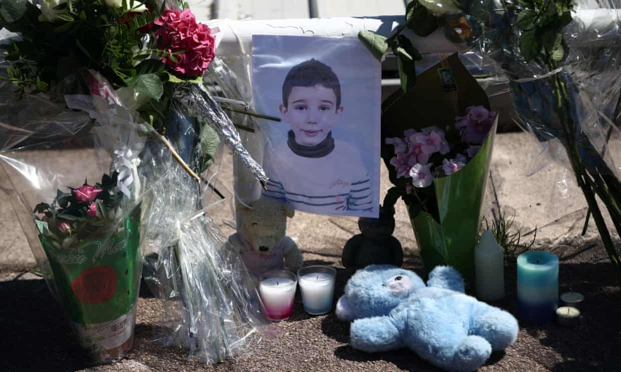 Flowers and a teddy bear are set around a photograph of a small boy killed in the attack on the Promenade des Anglais in Nice.
