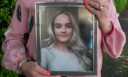 Nikki Lynne holds a photograph of her daughter, Angel, before she was injured in September 2020.