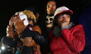Darren Seals stands behind Lezley McSpadden, the mother of Michael Brown, in front of the Ferguson police station as they learn that Darren Wilson would not be indicted.