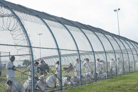 incarcerated women mending a prison fence