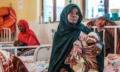 A woman holds a malnourished child at the nutrition unit of Gode General Hospital, in Gode, Ethiopia, on 11 January 2023. The last five rainy seasons since the end of 2020 have failed, triggering the worst drought in four decades in Ethiopia, Somalia and Kenya.