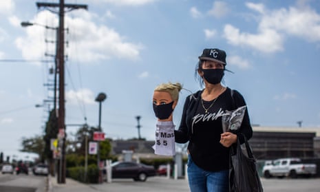 Los Angeles dressmaker Flor Hernandez sells face masks on street after losing her job.