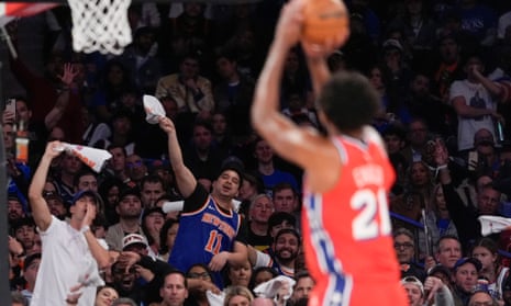 A Knicks fan tries to distract Joel Embiid at the free throw line. 