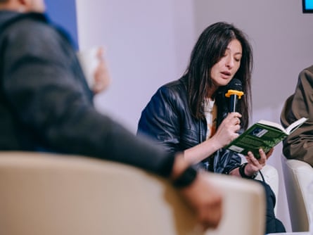 Kateryna Zarembo reading from a book on stage