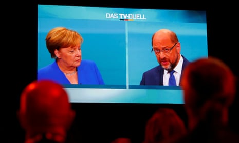 Journalists watch the TV debate between Angela Merkel and Martin Schulz in Berlin, Germany.