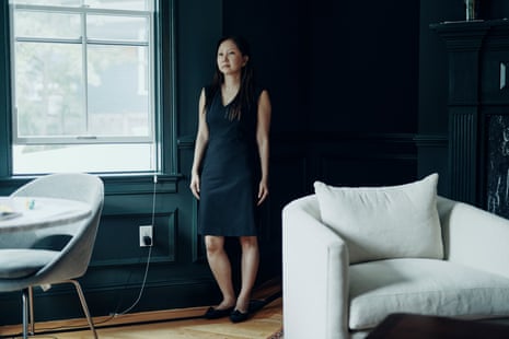 A woman poses for a photo inside a house