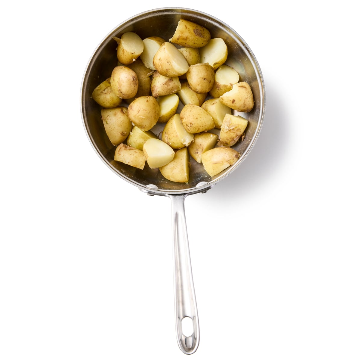 Felicity Cloake’s potato salad 06a. Drain the potatoes, put them back in the hot pan to steam dry, then cut in half or quarters.