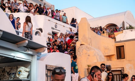 Crowds of tourists around building.