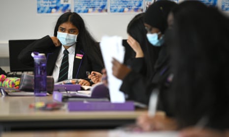 Children wearing facemasks during a lesson at Hounslow Kingsley Academy in West London, as pupils in England returned to school for the first time in two months as part of the first stage of lockdown easing.