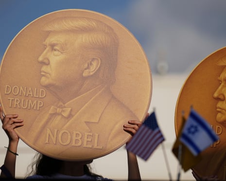 Images of Donald Trump held by demonstrators during a protest demanding the release of Israeli hostages, Tel Aviv, 2 September.