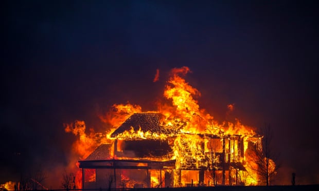 A home burns after a fast-moving wildfire swept through the Centennial Heights neighborhood of Louisville, Colorado on 30 December