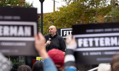 people hold fetterman signs