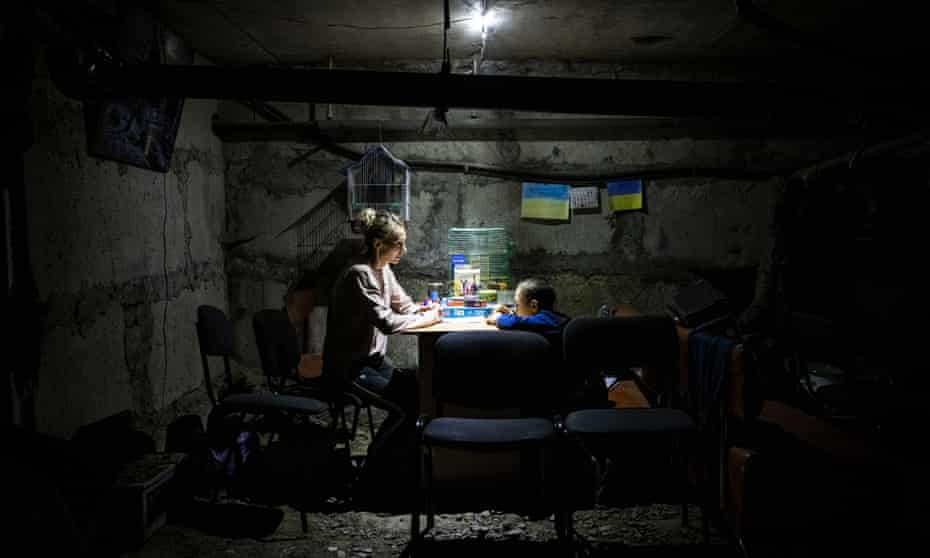 Tymofiy and his aunt Yana Sotnikova in the dark basement.