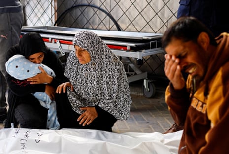 Relatives of a Palestinian baby who was born during the war and killed in an Israeli strike mourn at Abu Yousef al-Najjar hospital in Rafah