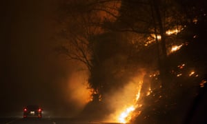 A fire rages next to Highway 441 near Gatlinburg, Tennessee.