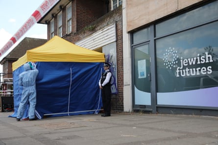 A police tent and officer stand outside the Jewish Futures shopfront