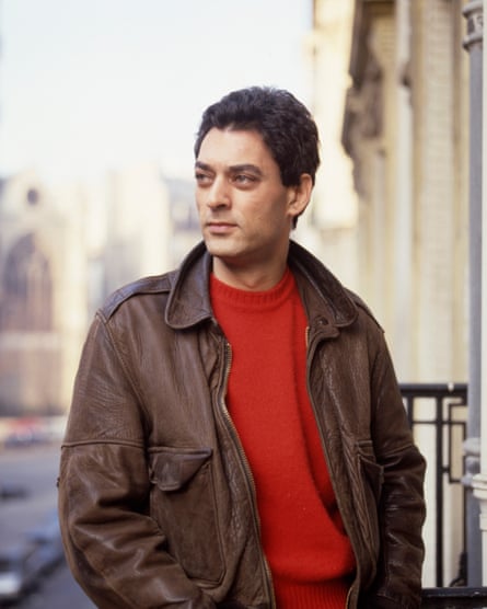 Paul Auster on a balcony looking out on to a street
