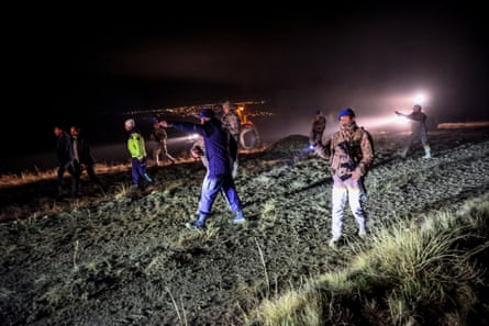 Rescue workers on a field in the dark