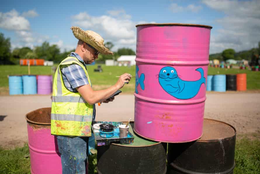 David Chadwick, AKA caravan Dave, paints sea creatures on bins in the market field