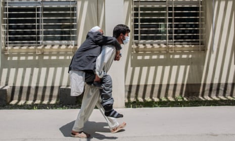 A patient is carried by a relative to the Afghan-Japan hospital in Kabul