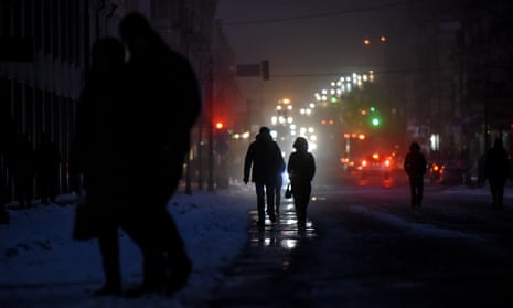 People walk in a street as life without electricity continues in Kyiv.