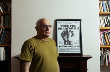 Tariq Mehmood, a member of the Bradford 12, with a poster from 1981. The poster says: Free the Bradford 12