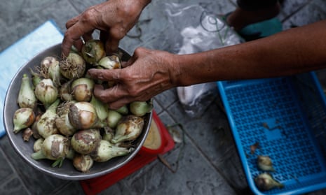 Onions are sold in a Manila market.
