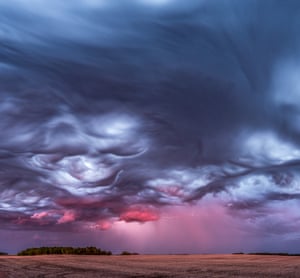 We stood in complete awe of this scene unfolding in front of us. Asperitas clouds are rare enough by themselves, but to have these undulating waves combine with a storm, rain, and the pink hues of sunset - well that was a once in a lifetime moment.