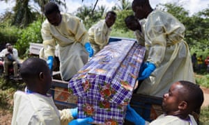Health workers take part in the funeral of an Ebola victim in the Democratic Republic of the Congo