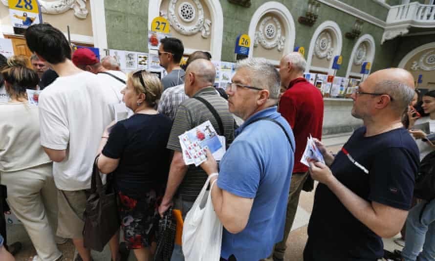 People queue for a new set of commemorative postal service stamps dedicated to the Ukrainian resistance, amid Russia’s invasion of Ukraine, at main postal office in Odesa, Ukraine.