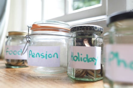 Glass jars on a counter labelled ‘food’, ‘pension’ and ‘holiday’