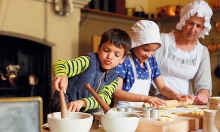 Children with a costumed interpreter, taking part in baking activities