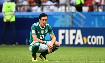 Mesut Özil in a sad crouching pose