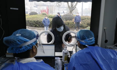 A patient attends a mobile fever clinic, converted from a nucleic acid testing booth, in Huzhou, Zhejiang Province of China, on Wednesday. 