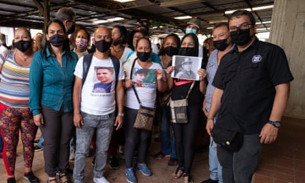 Relatives of young people murdered during alleged extrajudicial executions pose with activists from the NGOs Provea, Centro Gumilla and Lupa por la Vida, in Caracas in May 2022.