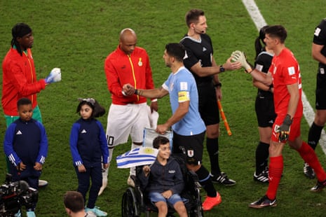 Luis Suarez shakes hands with the Ghana players.