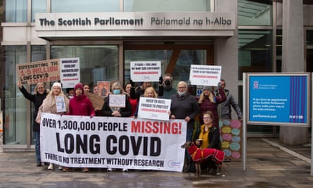 Long Covid campaigners with banners and signs outside the Scottish parliament