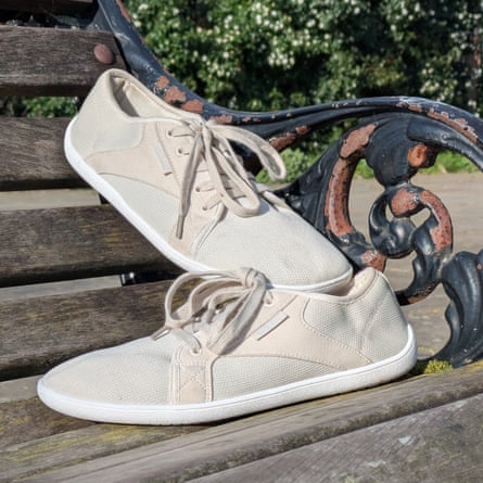 A pair of Saguaro Luck trainers are displayed on a park bench,