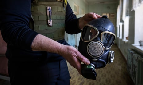 A medic holds a gas mask she was given at a hospital in Sloviansk.
