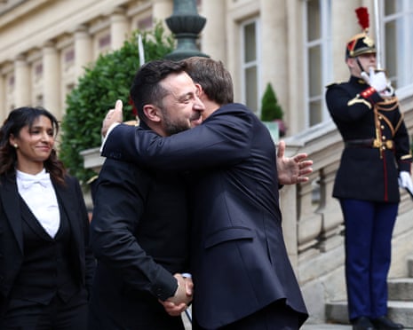 French president Emmanuel Macron shakes hands with Ukrainian President Volodymyr Zelenskyy.